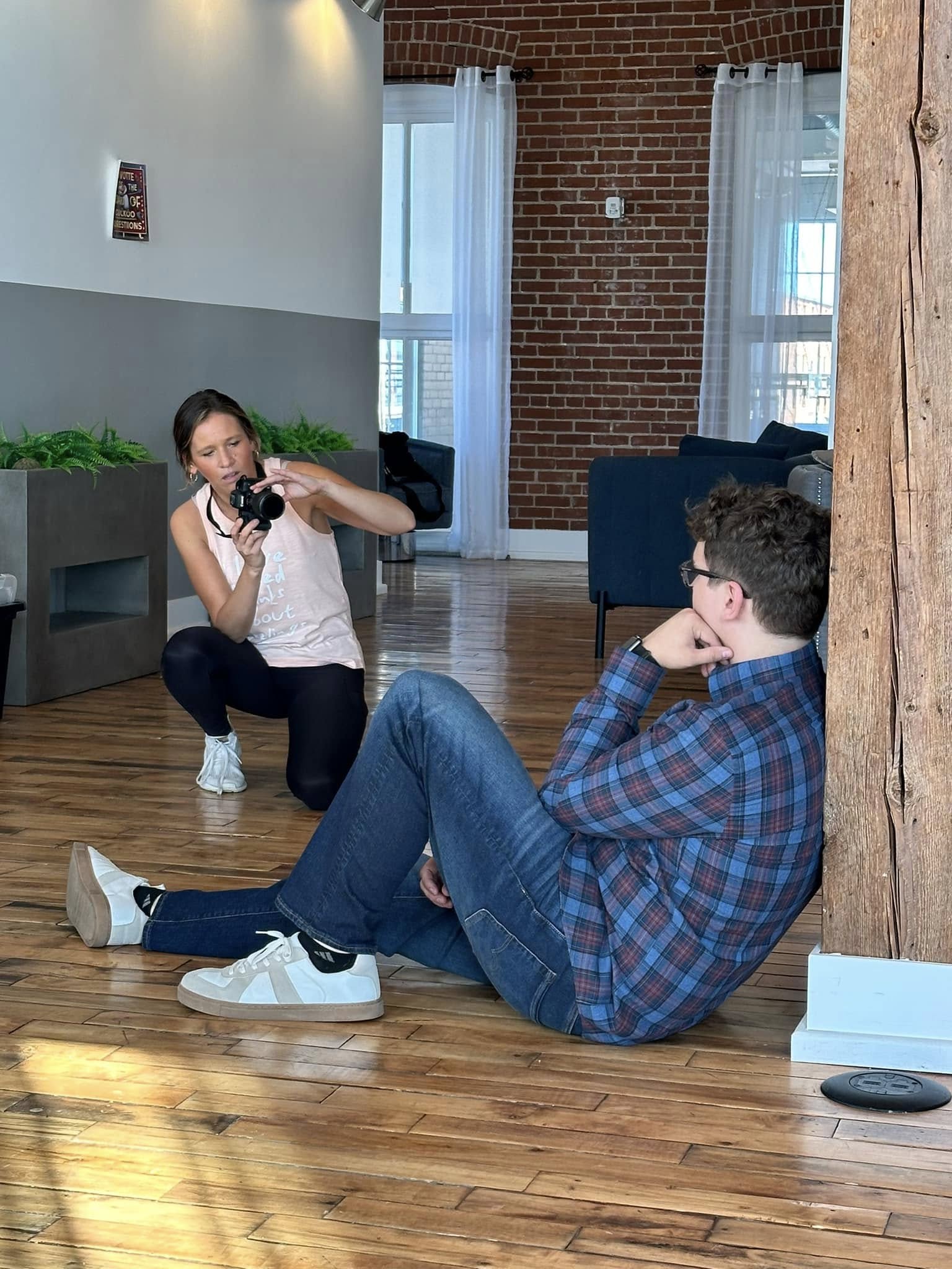 Kiley photographing a client in a downtown loft